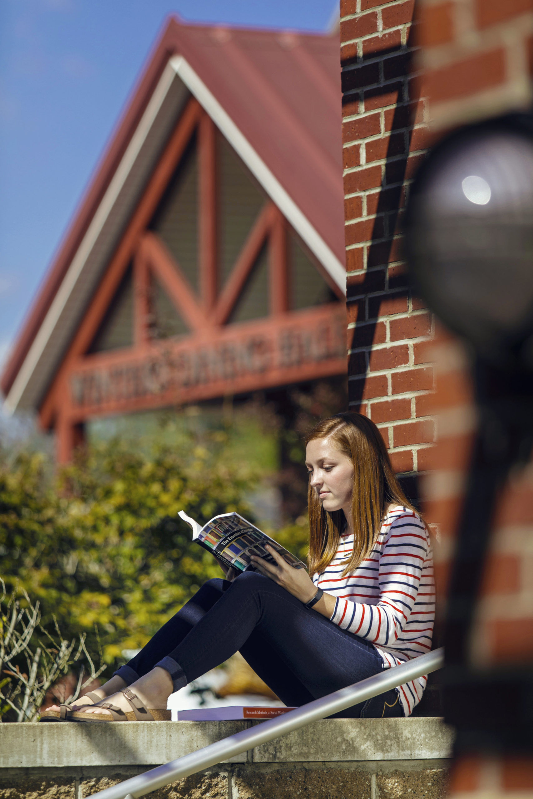 CU Windsor student studying outdoors on campus